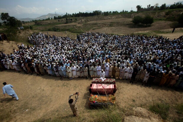 Relatives and mourners attend the funeral prayer of victims who were killed in Sunday's suicide bomber attack in the Bajur district of Khyber Pakhtunkhwa, Pakistan, Monday, July 31, 2023. Pakistan held funerals on Monday for victims of a massive suicide bombing that targeted a rally of a pro-Taliban cleric the previous day. (AP Photo/Mohammad Sajjad)