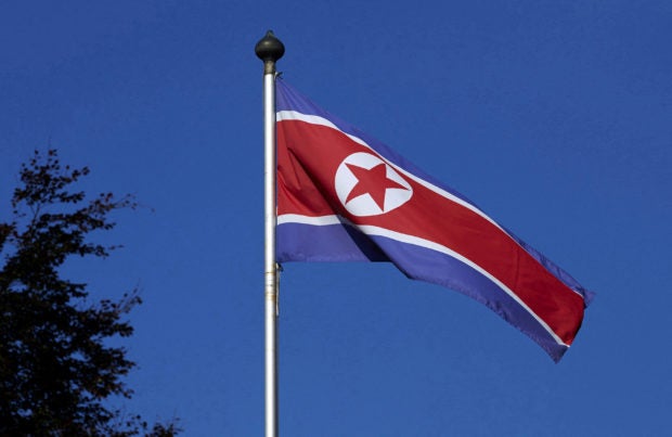 FILE PHOTO: A North Korean flag flies on a mast at the Permanent Mission of North Korea in Geneva south korea cyber