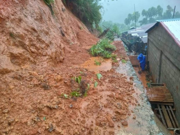 OBSTRUCTION This road in Sta. Praxedes, Cagayan, is waiting to be cleared of soil loosened by heavy rain accompanying Typhoon “Neneng” (Nesat), which also caused widespread flooding in northern Luzon on Sunday. —PHOTO COURTESY OF STA. PRAXEDESMDRRMO